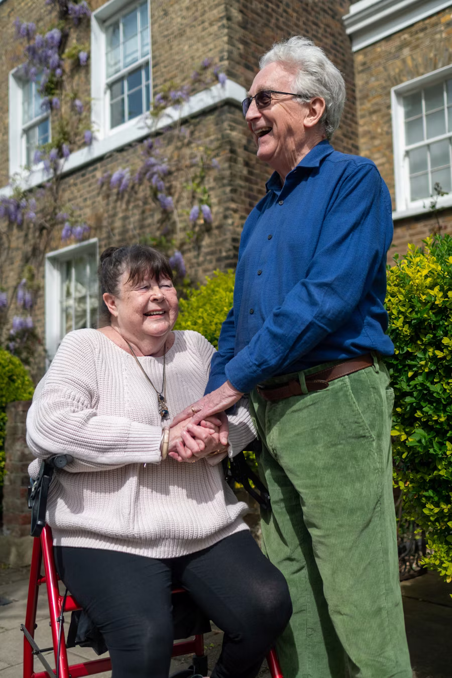 A caregiver gently helping a senior at home