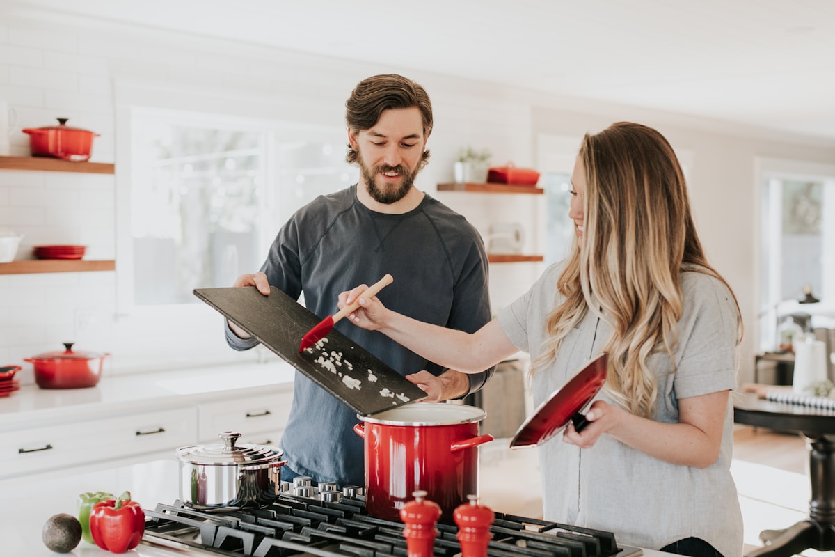 A bright kitchen with someone preparing a meal